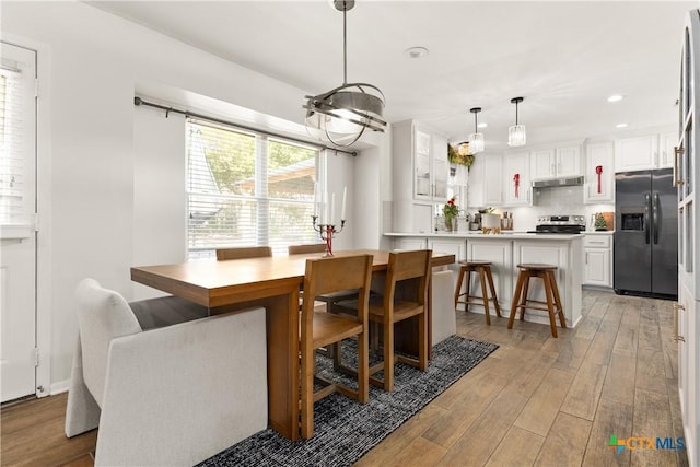 dining space featuring recessed lighting and light wood-style flooring