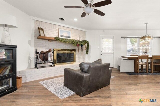 living room with visible vents, wood finished floors, recessed lighting, a fireplace, and ceiling fan