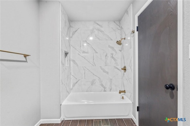 full bathroom with baseboards, shower / bathtub combination, and wood finish floors