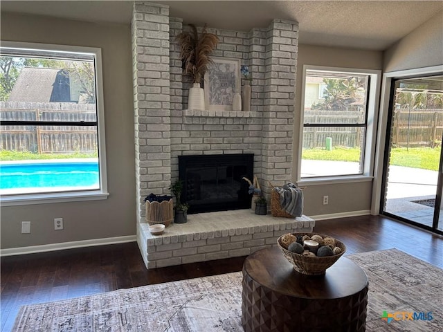living room with baseboards, a wealth of natural light, and wood-type flooring