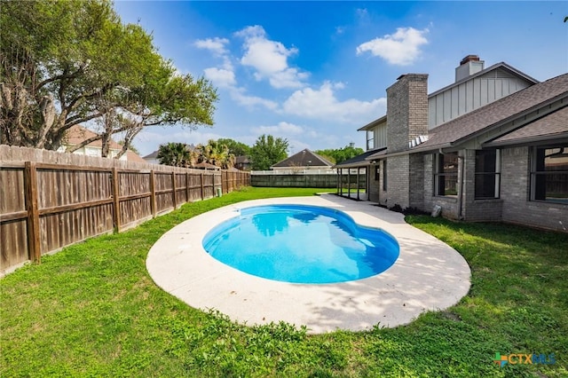 view of pool with a fenced backyard, a fenced in pool, and a lawn