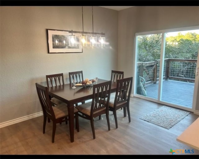 dining area with wood finished floors and baseboards