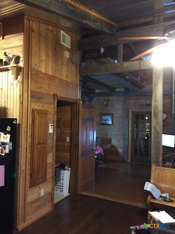 2911 Sulphur Wells Rd, Salado, TX 76571 - corridor with wood walls, dark wood finished floors, and visible vents