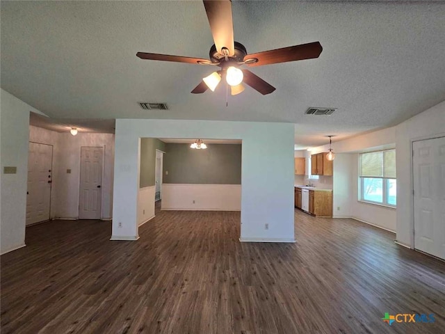 4709 Poppy Wood Cir, Killeen, TX 76542 - unfurnished living room featuring dark wood-style floors, a textured ceiling, ceiling fan, baseboards, and a chandelier
