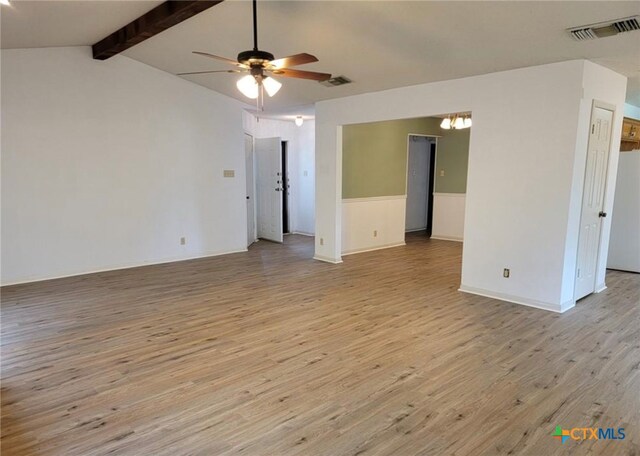 empty room featuring ceiling fan, light wood-type flooring, and lofted ceiling with beams