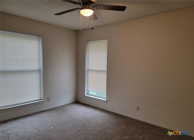 carpeted empty room featuring a textured ceiling and ceiling fan