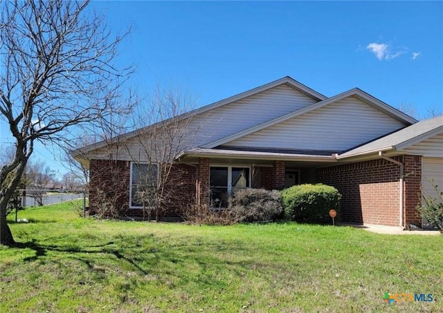 4709 Poppy Wood Cir, Killeen, TX 76542 - view of side of property featuring a yard, brick siding, and an attached garage