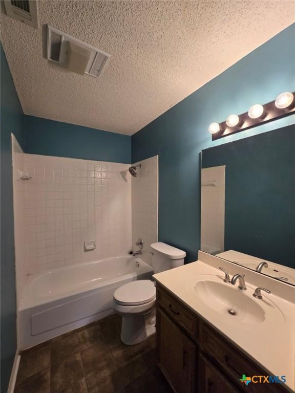 4709 Poppy Wood Cir, Killeen, TX 76542 - bathroom featuring shower / bath combination, a textured ceiling, toilet, and vanity