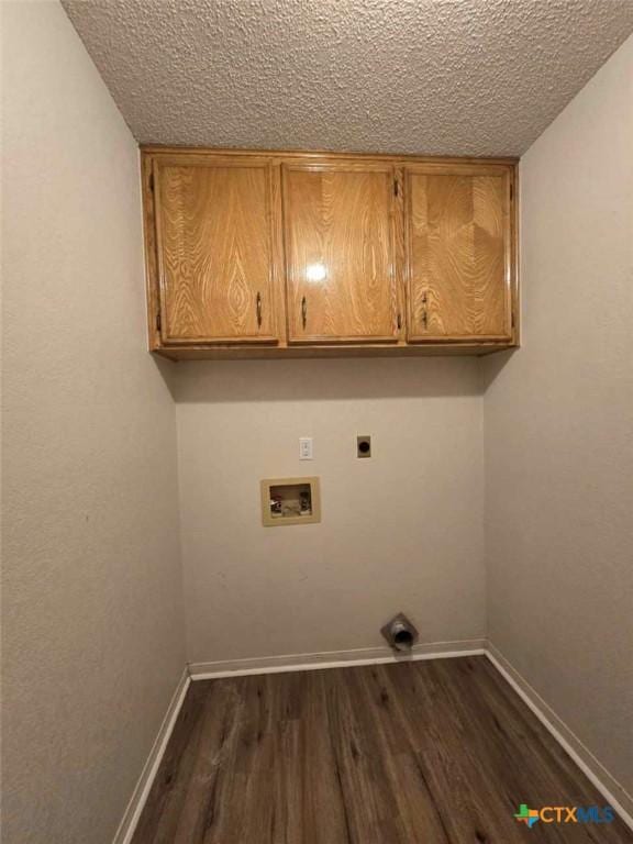 4709 Poppy Wood Cir, Killeen, TX 76542 - laundry area featuring cabinet space, electric dryer hookup, hookup for a washing machine, dark wood-type flooring, and a textured ceiling