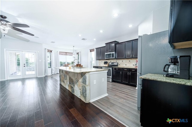 232 Pevero, Cibolo, TX 78108 - kitchen featuring stainless steel appliances, ceiling fan, a sink, wood finished floors, and light stone counters