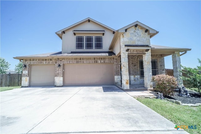 232 Pevero, Cibolo, TX 78108 - view of front of house with stone siding, concrete driveway, a standing seam roof, a garage, and brick siding
