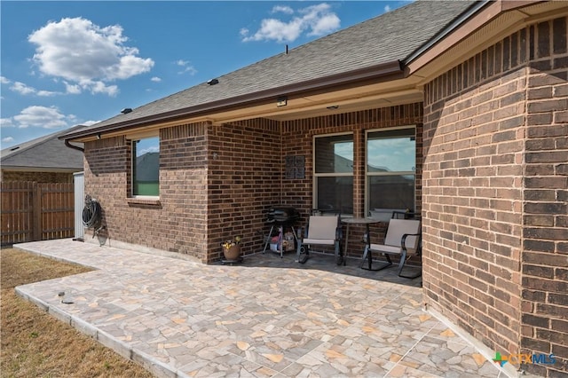 view of patio / terrace featuring grilling area and fence