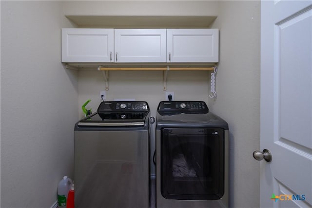 laundry area with cabinet space and separate washer and dryer