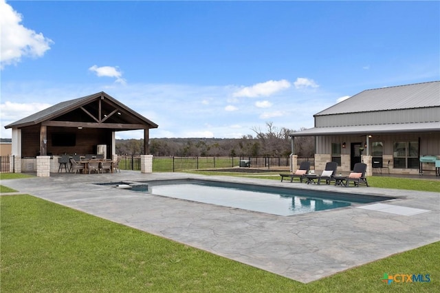 view of pool with a patio, a lawn, and an outdoor bar