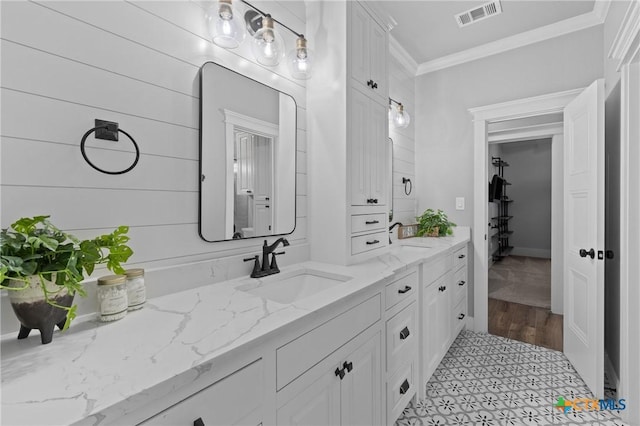 bathroom with vanity and ornamental molding