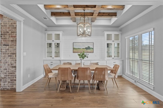 dining room featuring coffered ceiling, a notable chandelier, beam ceiling, and light hardwood / wood-style floors