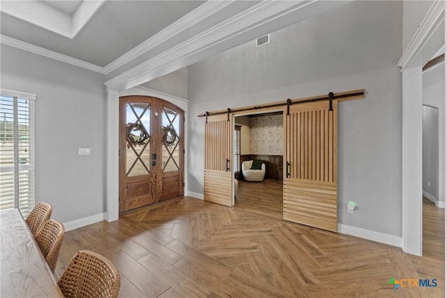 entryway featuring a barn door, ornamental molding, parquet flooring, and french doors