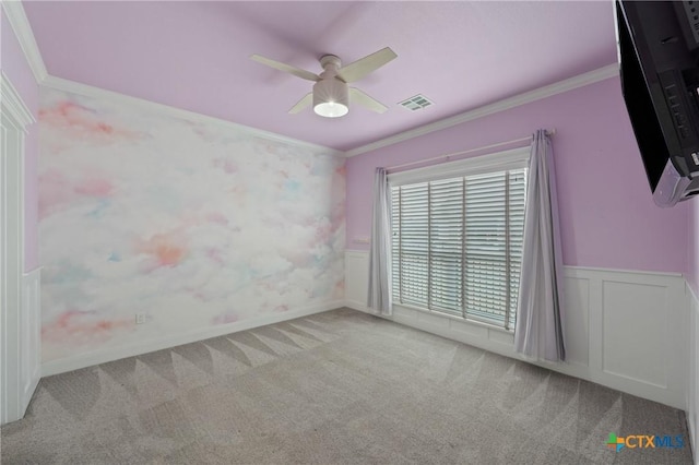 unfurnished room featuring crown molding, ceiling fan, and light carpet