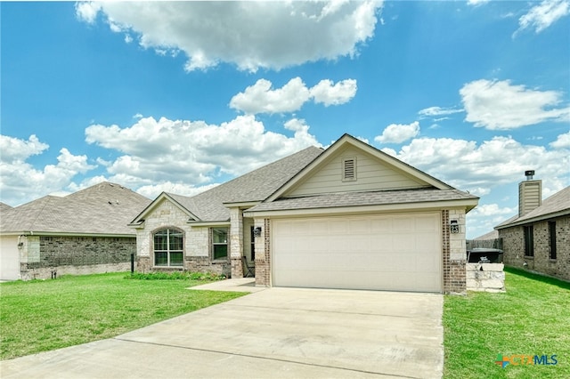 view of front of house with a front yard and a garage