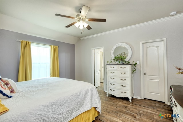 bedroom with ceiling fan, dark wood-type flooring, lofted ceiling, and ornamental molding