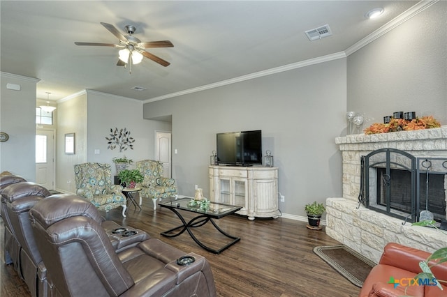 living room with ceiling fan, dark hardwood / wood-style flooring, ornamental molding, and a fireplace