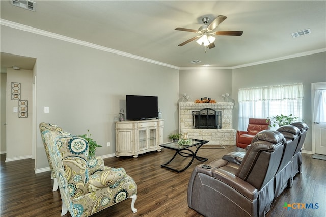 living room featuring a fireplace, ornamental molding, ceiling fan, and dark wood-type flooring