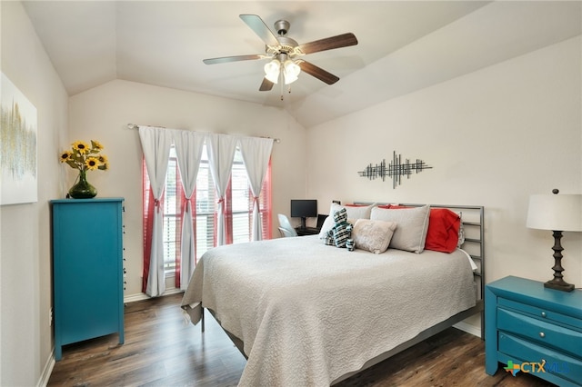 bedroom with vaulted ceiling, ceiling fan, and dark wood-type flooring