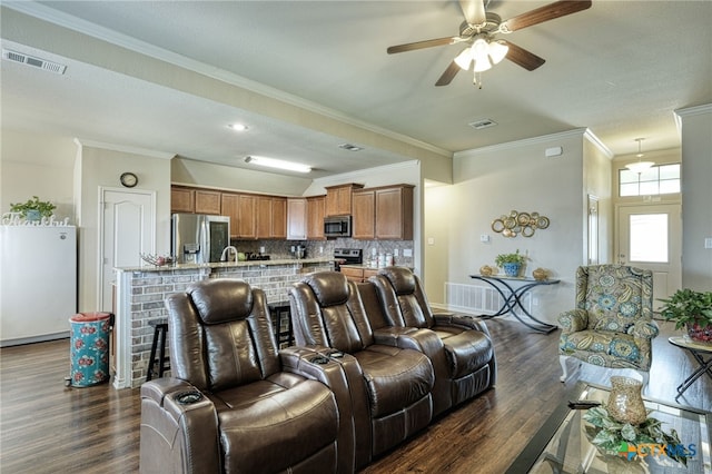 living room with dark hardwood / wood-style flooring, ceiling fan, crown molding, and sink