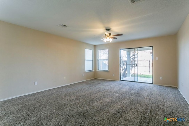 carpeted spare room featuring ceiling fan