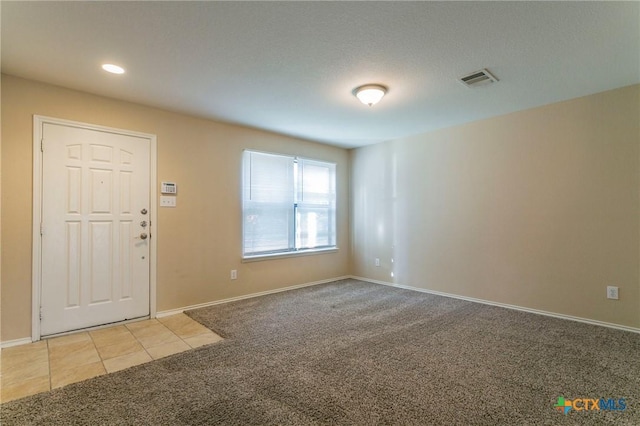 view of carpeted foyer entrance