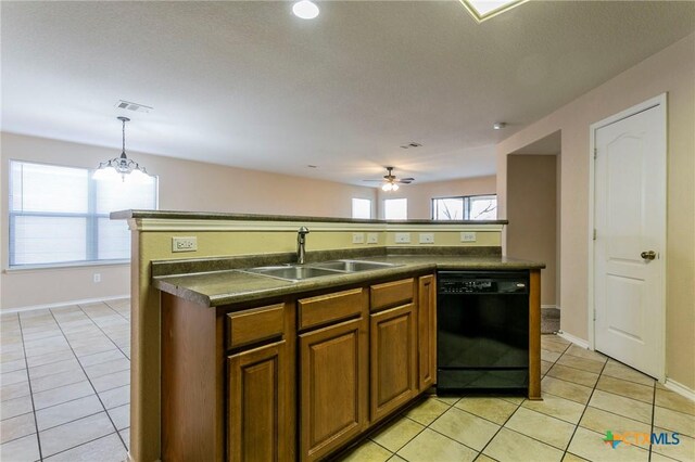 kitchen featuring dishwasher, an island with sink, hanging light fixtures, and sink