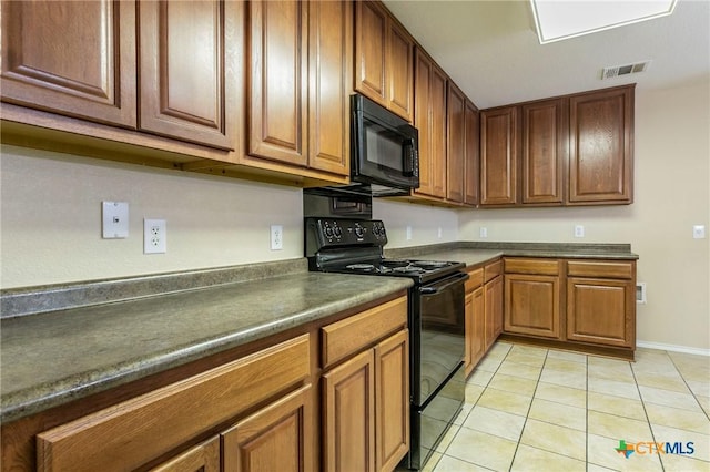 kitchen with light tile patterned floors and black appliances