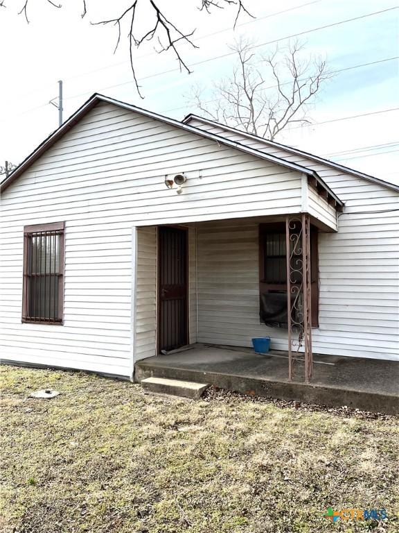 rear view of house with a lawn