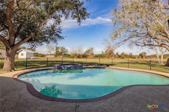 view of swimming pool with an in ground hot tub