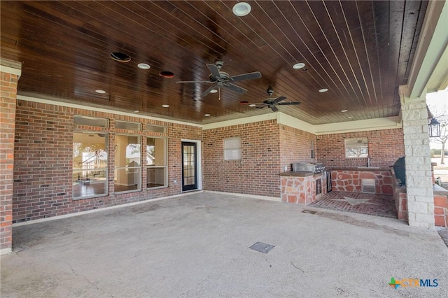 view of patio with ceiling fan and exterior kitchen