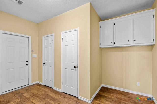 entrance foyer with hardwood / wood-style flooring and a textured ceiling