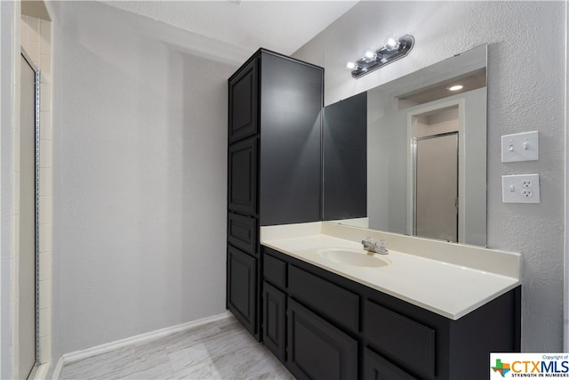 bathroom featuring an enclosed shower and vanity