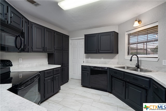 kitchen with a textured ceiling, black appliances, and sink