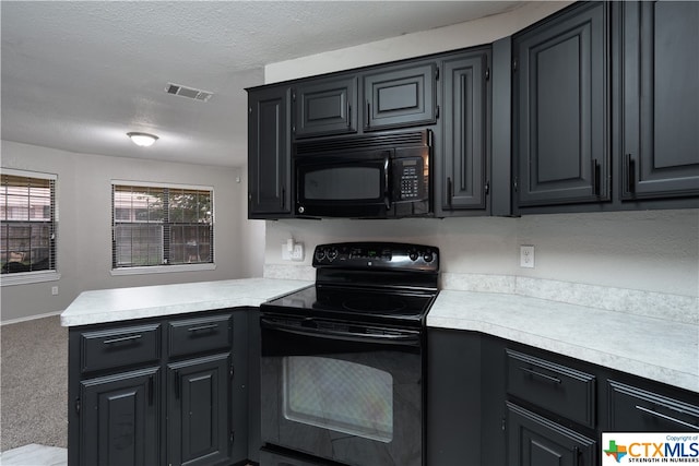 kitchen featuring black appliances, a textured ceiling, and carpet flooring