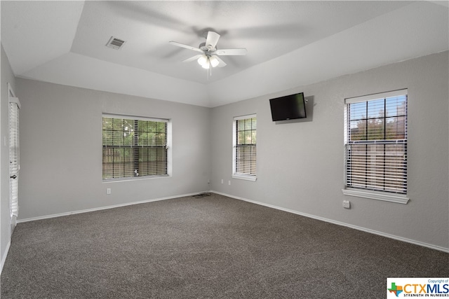 carpeted spare room featuring ceiling fan and a tray ceiling