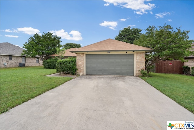 ranch-style house with a front lawn and a garage