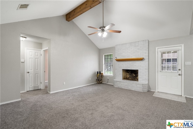 unfurnished living room featuring a brick fireplace, lofted ceiling with beams, light carpet, and ceiling fan