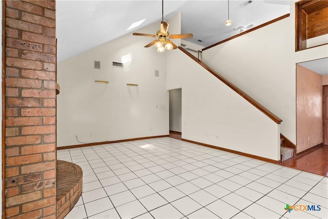 unfurnished living room with ceiling fan, high vaulted ceiling, light tile patterned floors, baseboards, and stairs