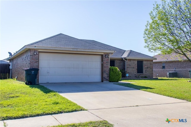ranch-style home with brick siding, a front lawn, fence, and a garage