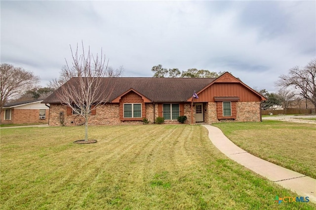 single story home with brick siding, board and batten siding, and a front yard