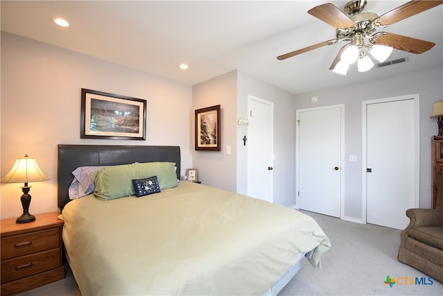 bedroom featuring light carpet and ceiling fan