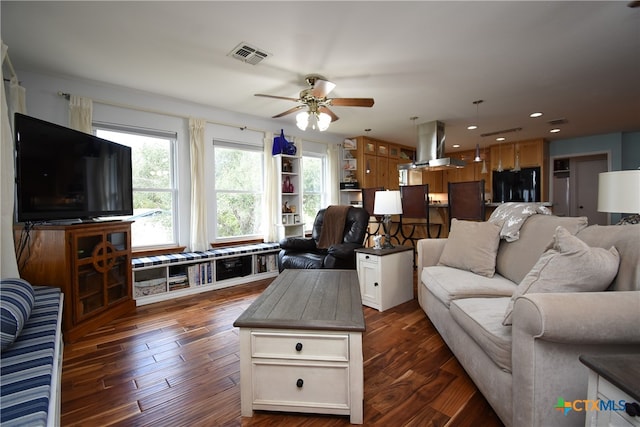 living room with ceiling fan and dark hardwood / wood-style floors