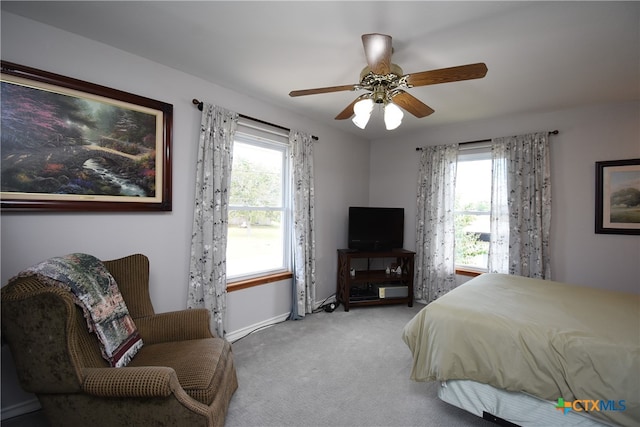 bedroom with ceiling fan and light carpet