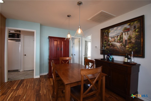 dining space featuring dark wood-type flooring