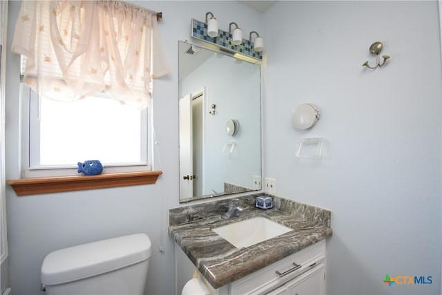 bathroom with vanity and toilet